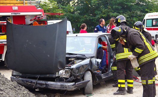 Val Della Torre, Italy - September, 28 2014: Simulation of road accidents, joint intervention between firefighters and rescuers (Red Cross).  Demonstration held in September 2014  in the province of Turin in Piedmont (Italy)