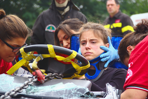 Val Della Torre, Italy - September, 28 2014: Simulation of road accidents, joint intervention between firefighters and rescuers (Red Cross).  Demonstration held in September 2014  in the province of Turin in Piedmont (Italy)