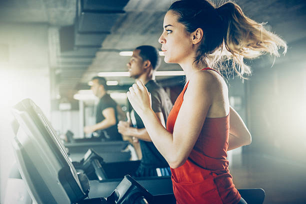 Diverse People Running on Treadmill Diverse People Running on Treadmill gym photos stock pictures, royalty-free photos & images