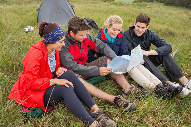 istock Friends sitting down looking at map on camping trip 500889075