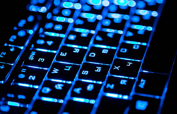 istock Blue lighting keyboard in the dark closeup 500890635