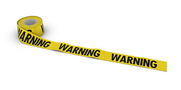 istock WARNING Tape Roll unrolled across white floor 500897590