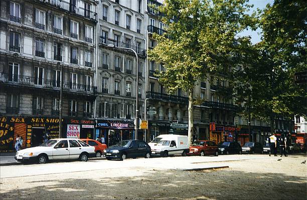Paris, France - August 1, 1998: People walking in Pigalle, an area around the Place Pigalle.