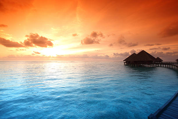 istock maldivian houses on sunrise 500905591