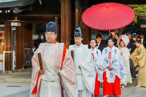 Tokyo, Japan - November 23 2013: Unidentified groom and bride attend a traditional wedding ceremony at Meiji shrine
