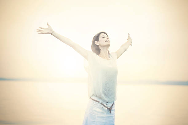 istock beautifull woman taking a deep breath at the sunset 500906539