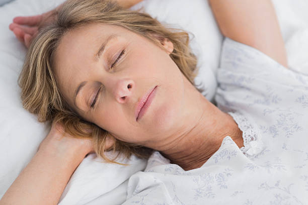 istock Woman sleeping peacefully in bed close up 500907241