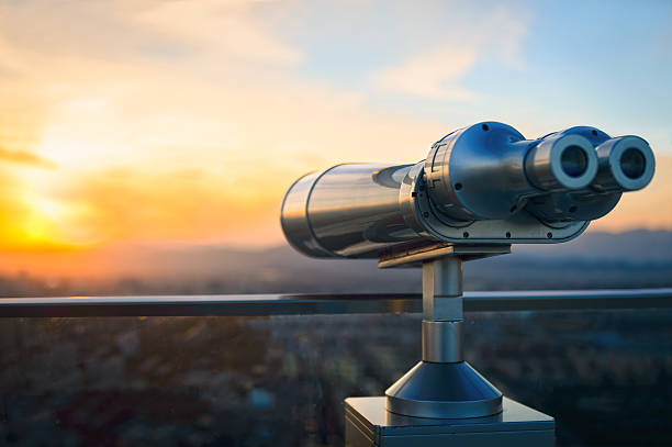 Observation Binoculars Binoculars or telescope on top of skyscraper at observation deck to admire the city skyline at sunset.Telescope located on the Beijing Olympic Tower telescope photos stock pictures, royalty-free photos & images