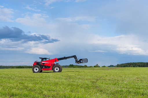 Red telescopic handler in the Lithuanian fields