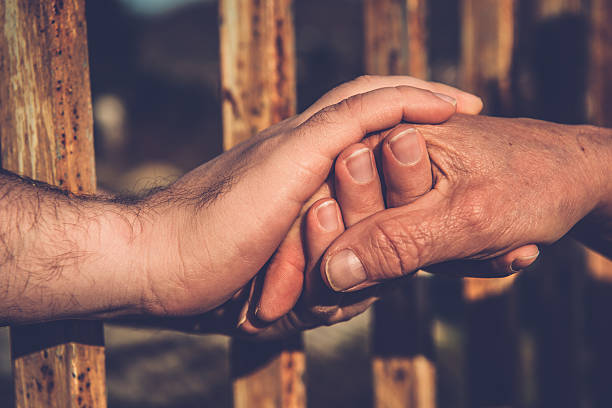 Image of the hands of a group of castellers, that join to support the human castle that they try to do. Version in color