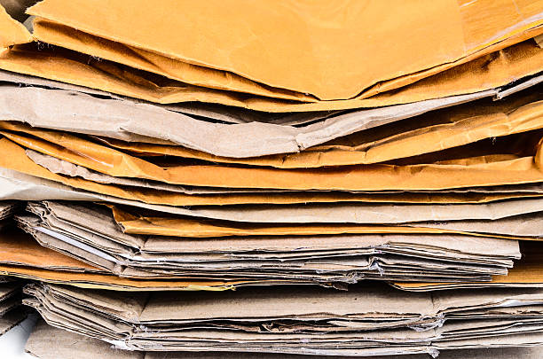 istock pile of brown envelope and cardboard box for recycling 500910616