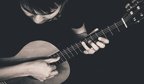 istock Asian Musician plays Acoustic Guitar 500911085