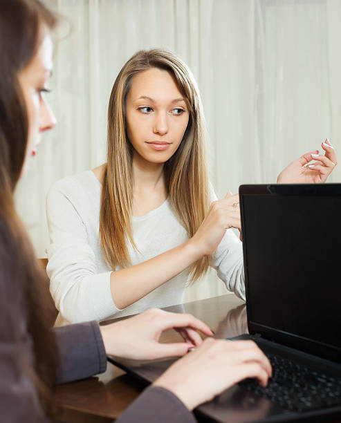 istock girl talking with employee with notebook 500911647