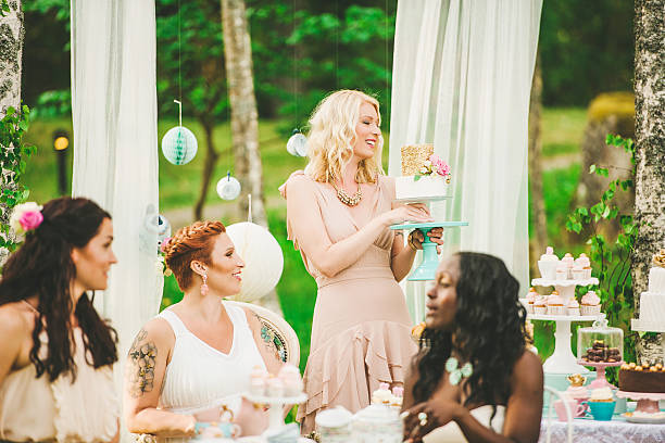 istock Women having a garden party with dessert table 500921253