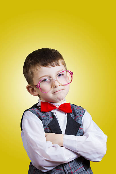 istock Confident little boy nerd isolated over yellow background. 500924162
