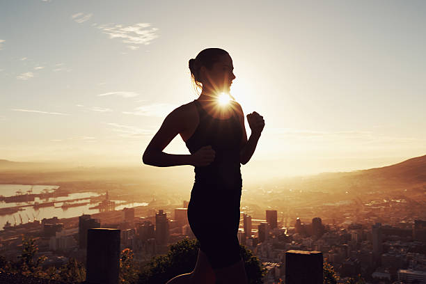 Up early for her morning jog Shot of a beautiful young woman training at sunrisehttp://195.154.178.81/DATA/i_collage/pi/shoots/783460.jpg sportsman professional sport side view horizontal stock pictures, royalty-free photos & images