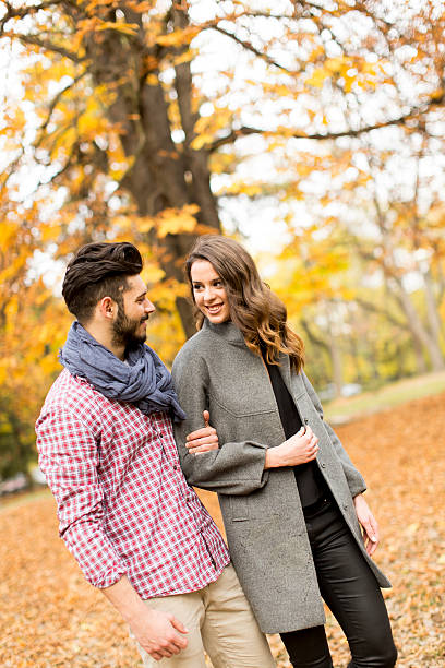 istock Young couple in the autumn park 500925336