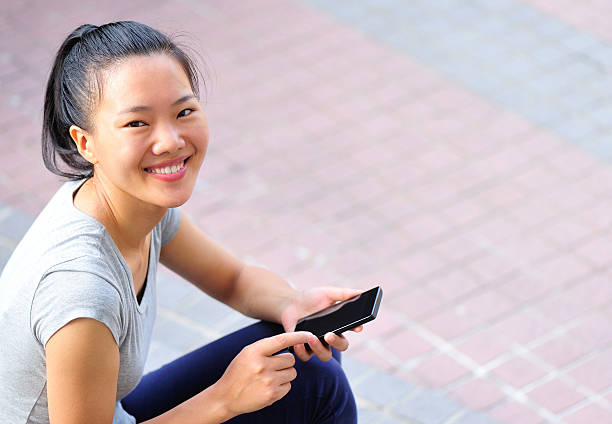 istock young  woman using smart phone at city 500926931