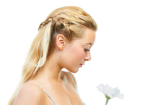 Portrait of a young beautiful teenager girl in a blooming spring green garden.
