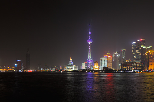 Shanghai, China - May 2, 2014: A skyline view across the Bund at night. Shanghai is a beautiful city of impressive contemporary architecture