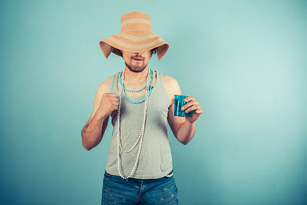 istock Happy young man wearing beach hat is drinking 500927943