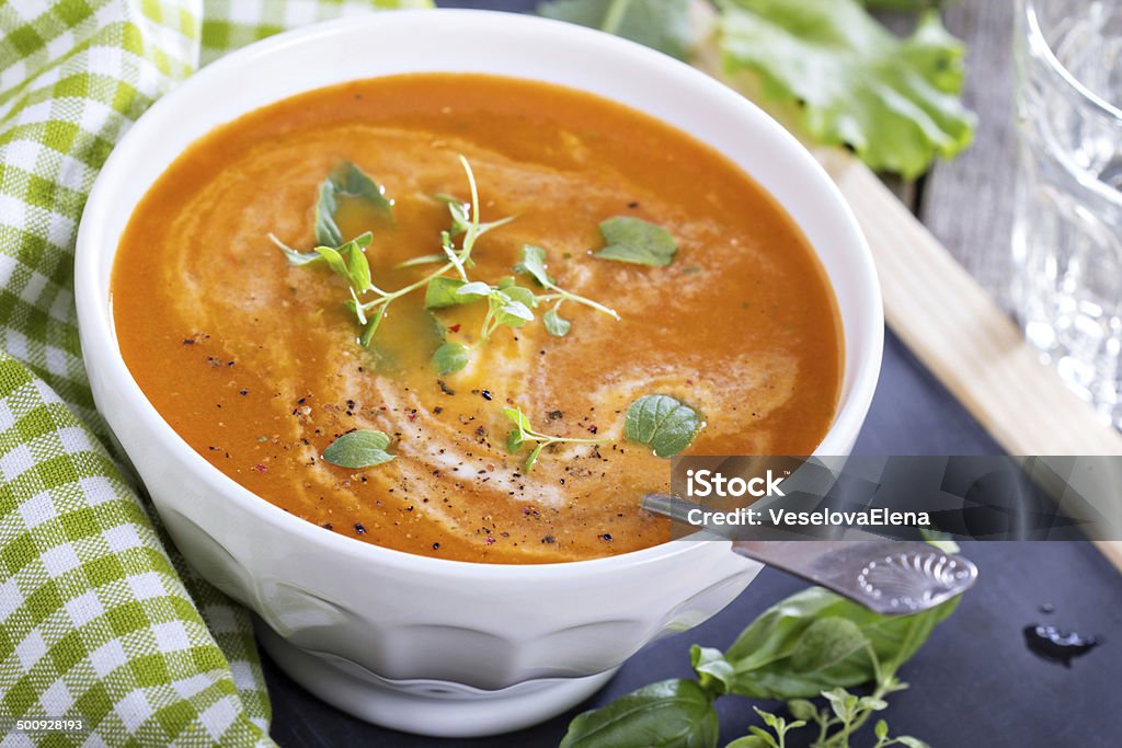 Tomato soup in white bowl Tomato soup with herbs in white bowl Appetizer Stock Photo