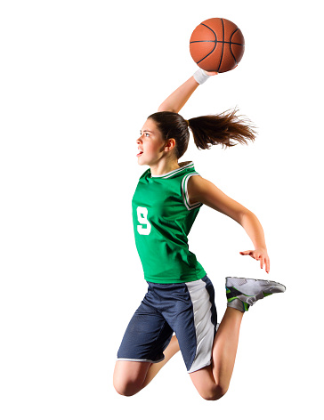Young girl, basketball player in motion, running with ball against blue studio background in neon light. Concept of professional sport, action and motion, game, competition, hobby, ad