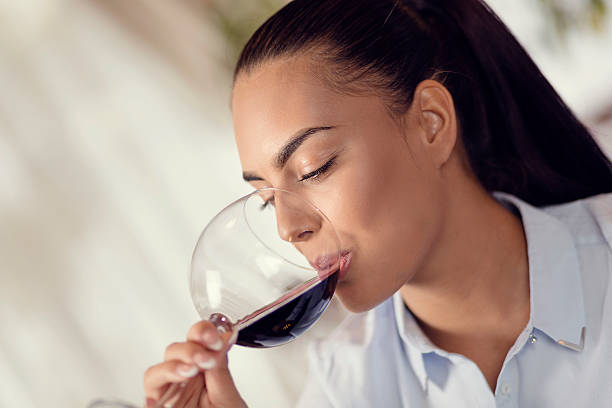 istock Young woman drinking red wine 500933624