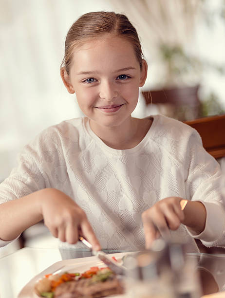 istock Young girl eating in a restaurant 500934126