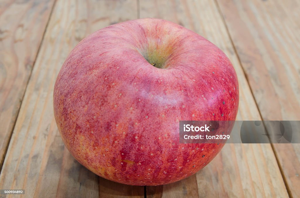 Ripe red apple. Put on a wooden table Ripe red apple. Put on a wooden table. Brown Stock Photo
