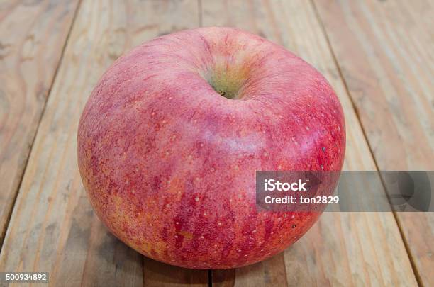 Ripe Red Apple Put On A Wooden Table Stock Photo - Download Image Now - Brown, Close-up, Food