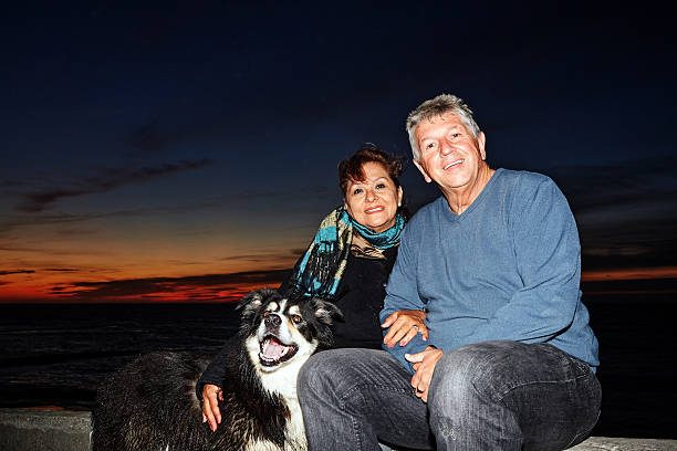 istock Mature smiling couple and dog at sunset 500935146