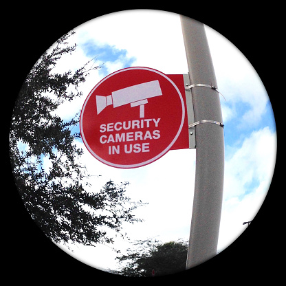 Security camera surveillance warning and disclosure sign. Fisheye view.