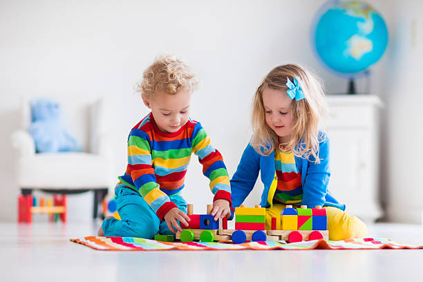 istock Kids playing with wooden toy train 500939056