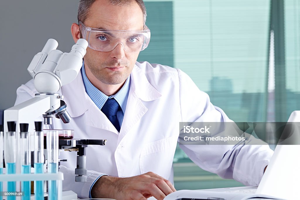 Test results Young scientist sitting at table looking at camera 30-39 Years Stock Photo