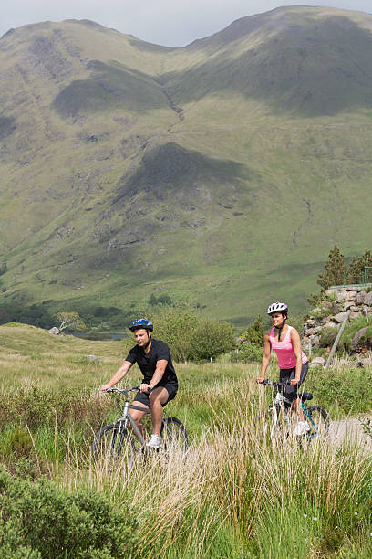 istock Athletic couple biking through wilderness 500942653