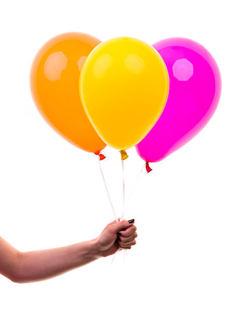 istock Colorful Balloons held by Female Hand. On White Background 500943707