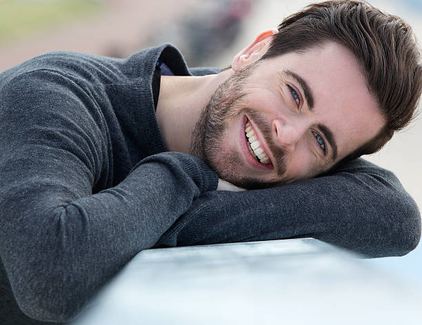 istock Charming young man smiling outdoors 500944937
