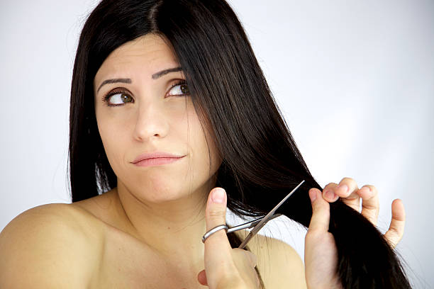 istock Beautiful female model dubious about cutting her long black hair 500947711