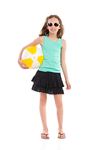 маленькая девочка с пляжный мяч - little girls pre adolescent child standing isolated стоковые фото и изображения
