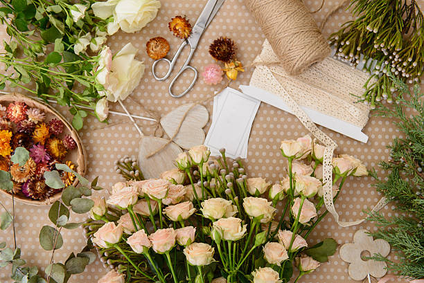 istock Florist workplace: flowers and accessories on the table. Top vie 500956580