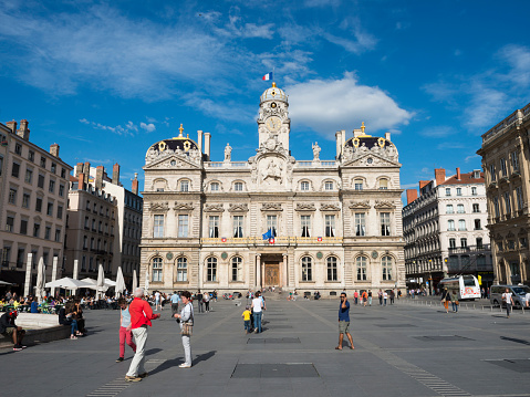 Lyon, France - May 23, 2014: Pedestrians walk outside the HÃ´tel de Ville, or City Hall, located on the Place des Terreaux in Lyon, France.