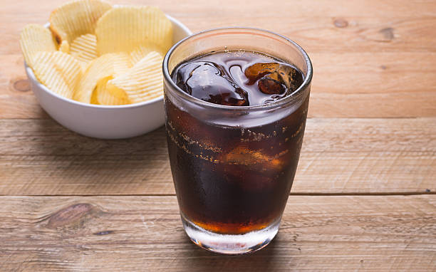 istock Cola and potato chips on a wooden background 500963534