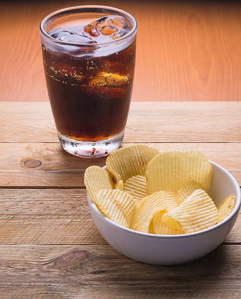 istock Cola and potato chips on a wooden background 500963966