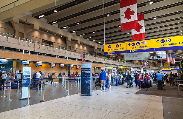 Calgary International Airport Calgary, Сanada - July 14, 2014: Busy passengers at the Calgary International Airport terminal. Opened in 1938, the airport offers non-stop flights to major cities in North America, Europe and East Asia. airports canada stock pictures, royalty-free photos & images