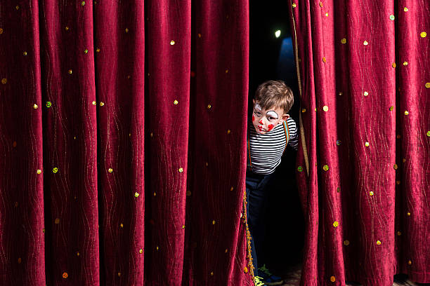 istock Anxious young actor looking out from the curtains 500965750