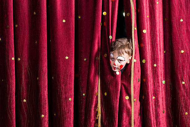 istock Impatient young actor peeking out from the curtain 500965954
