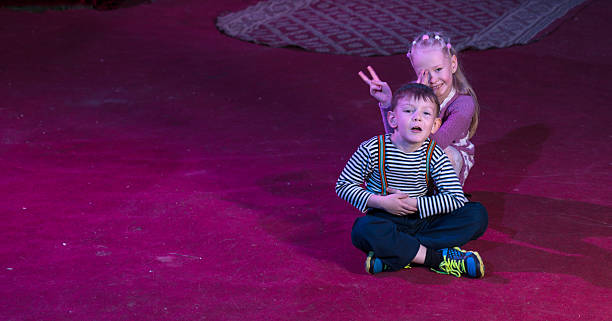 istock Boy and Girl Seated Together on Stage 500967340