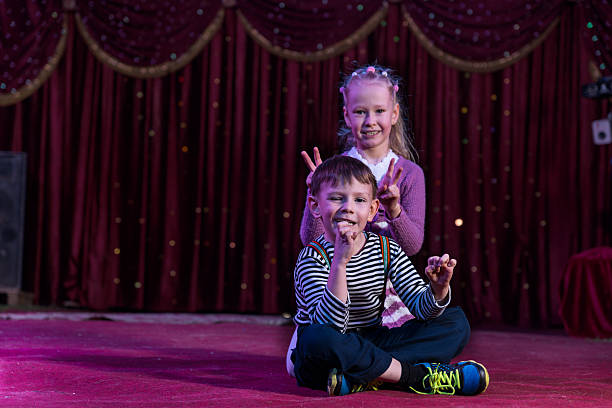 istock Boy and Girl Sitting Together on Stage 500967528