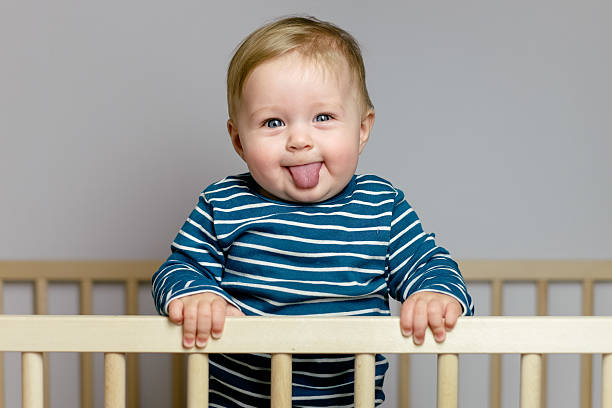 Baby in the crib Baby playing in the crib babies only stock pictures, royalty-free photos & images